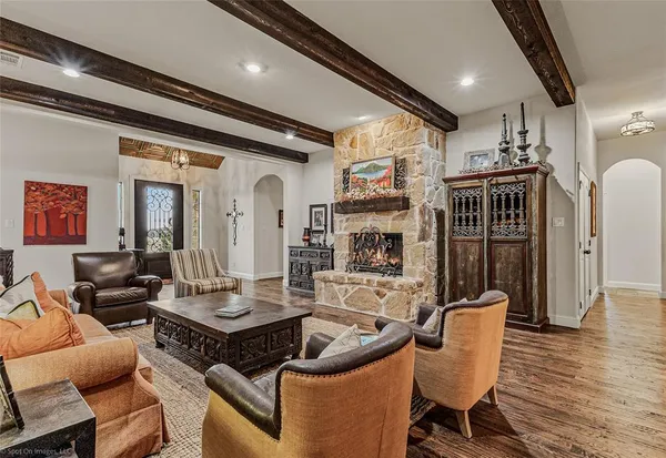 a living room with fireplace furniture and a wooden floor