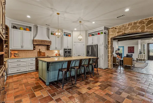 a large kitchen with lots of counter space and windows