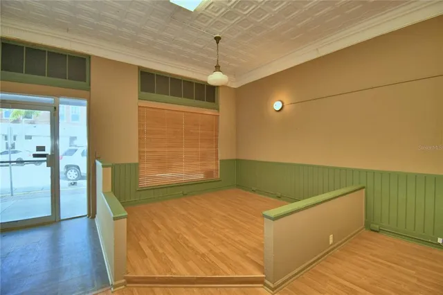 a view of an empty room with wooden floor