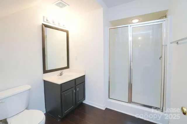 a bathroom with a toilet a sink a vanity and mirror