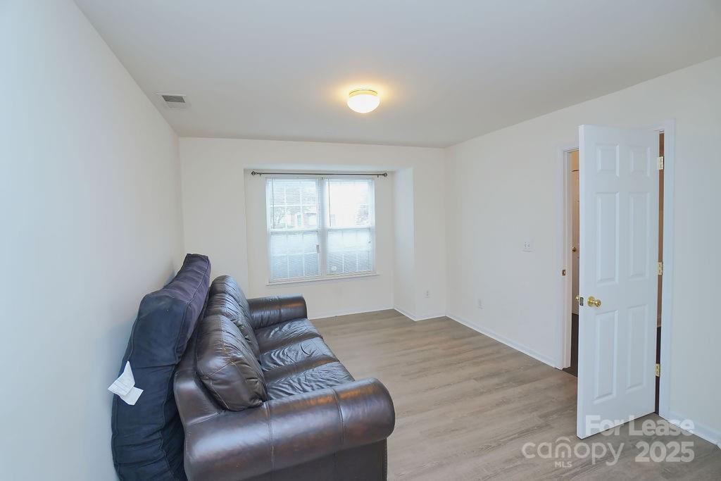 9858 Treeside Lane Matthews, NC 28105 - Photo 13 of 22 a living room with furniture and a window