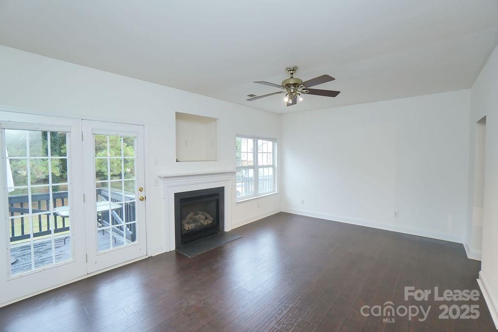 9858 Treeside Lane Matthews, NC 28105 - Photo 4 of 22 a view of an empty room with wooden floor and a window