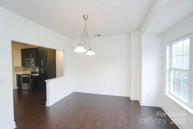 a view of a kitchen with a sink wooden floor and a living room