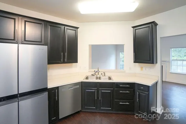 a bathroom with a double vanity sink and mirror