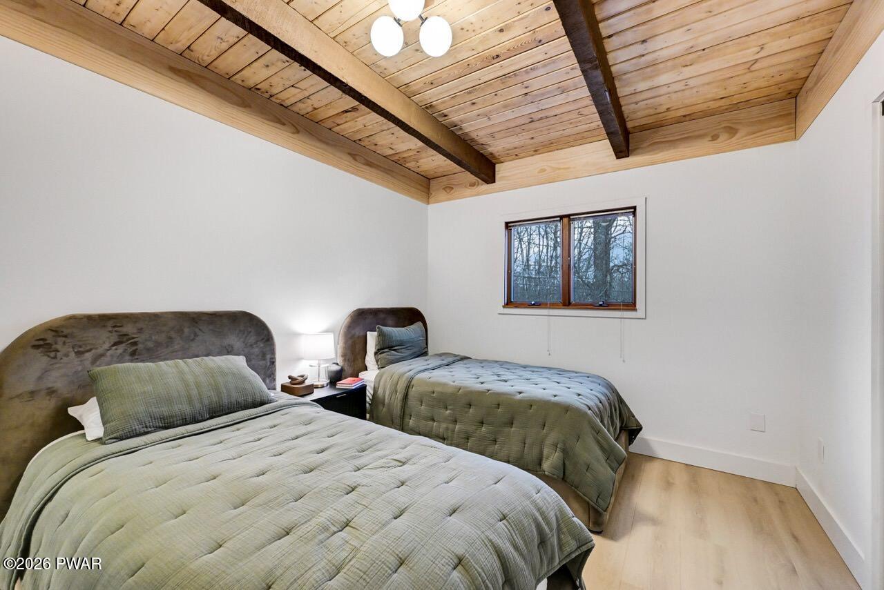258 Lakeview Road Lackawaxen, PA 18435 - Photo 30 of 119 a bedroom with two beds and a painting on the wall