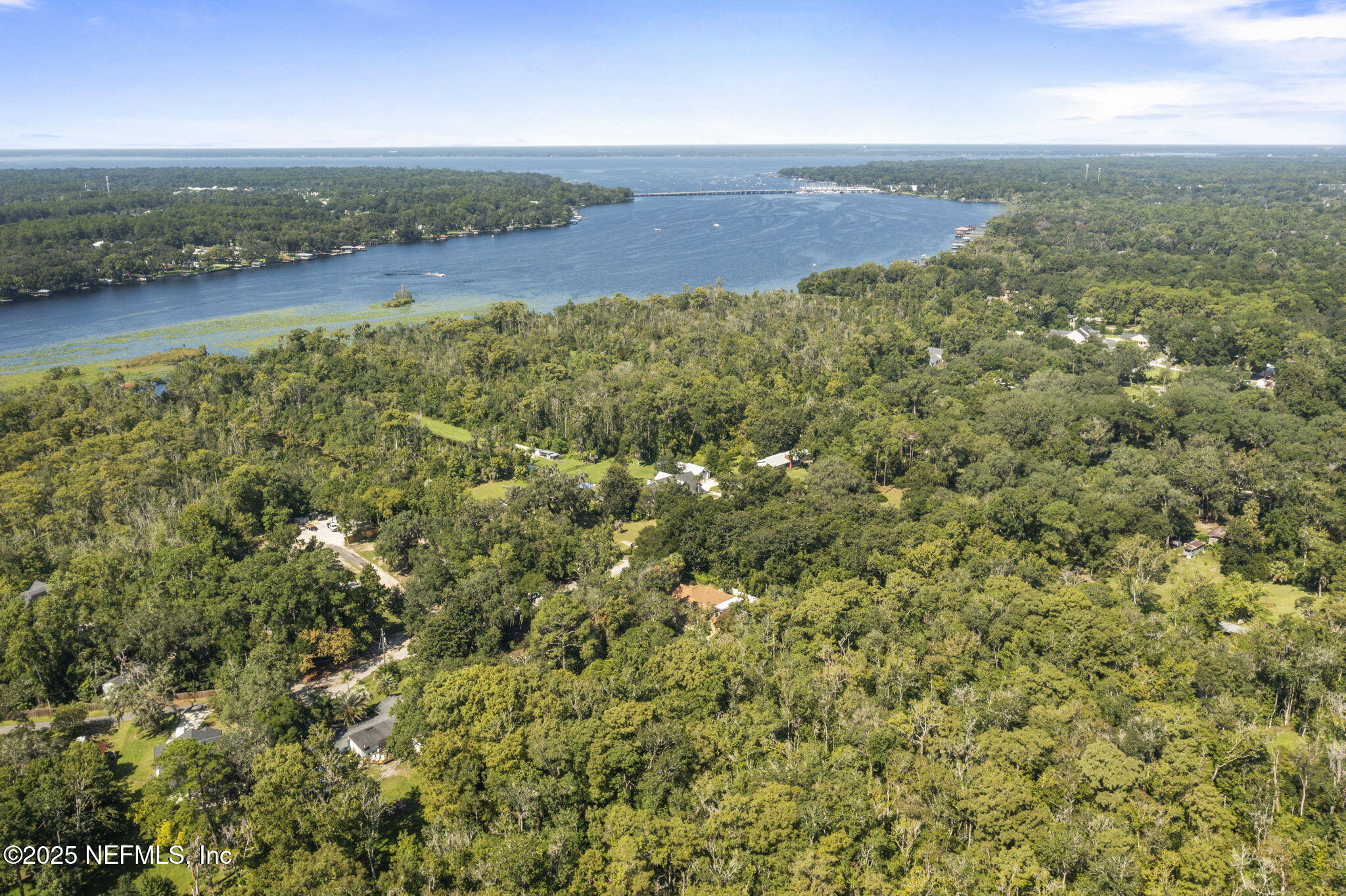 an aerial view of a houses with a yard