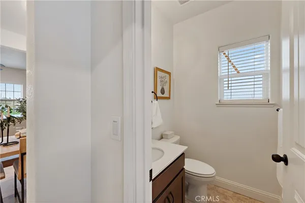 a bathroom with a granite countertop toilet and a sink