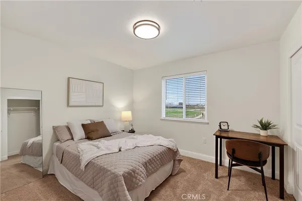 a bedroom with a bed and a window