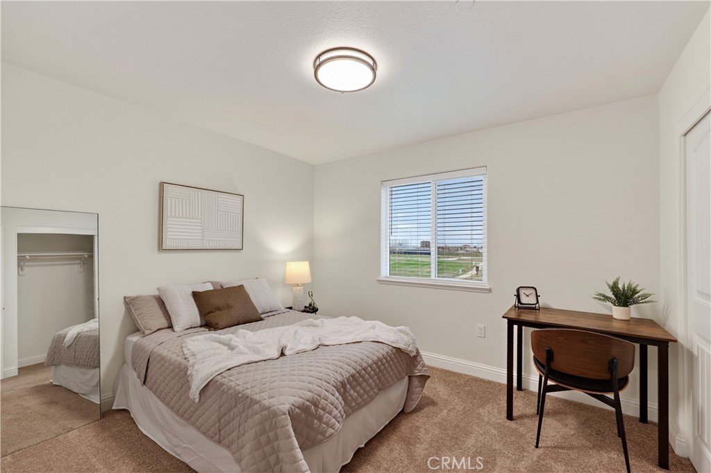 184 Montage Drive Merced, CA 95348 - Photo 22 of 32 a bedroom with a bed and a window