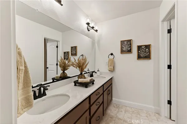 a bathroom with a sink double vanity and a mirror