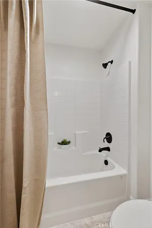 a bathroom with a bathtub and shower
