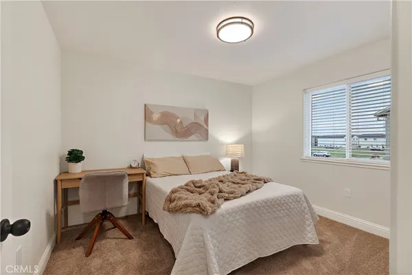 a bedroom with a bed and a desk