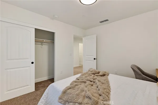 a bedroom with a bed and a dresser