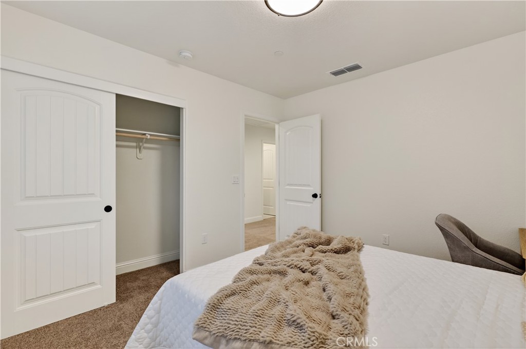 184 Montage Drive Merced, CA 95348 - Photo 27 of 32 a bedroom with a bed and a dresser
