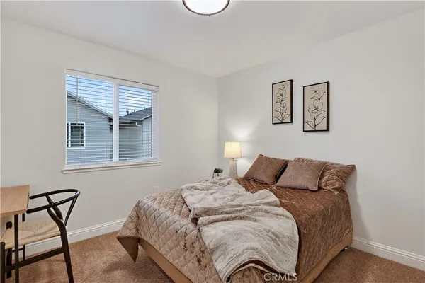 a bedroom with a bed and chair