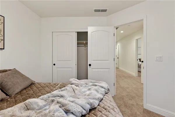 a bedroom with a bed and hallway