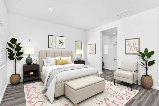 a spacious bedroom with a bed a couch and potted plant