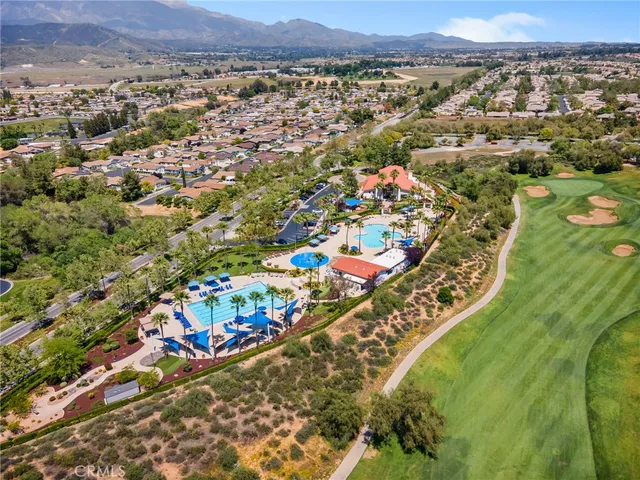 an aerial view of residential houses with outdoor space and trees