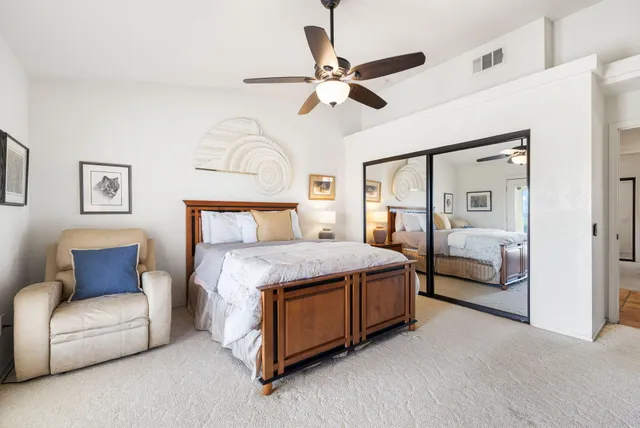 a bedroom with a bed a couch and dresser