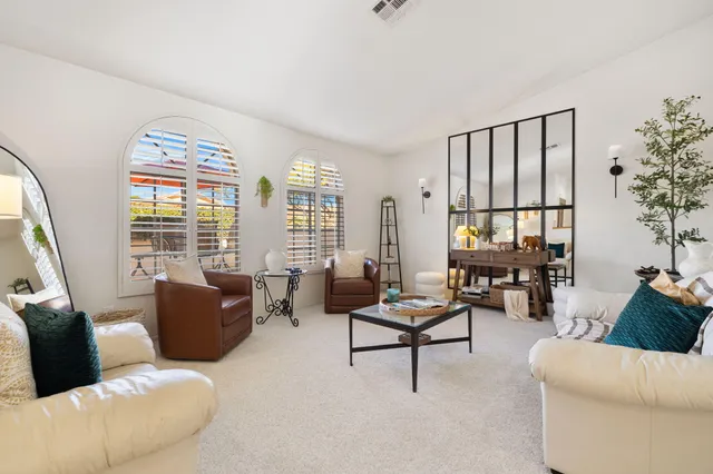 a living room with furniture and a large window