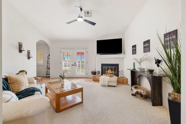 a living room with furniture fireplace and a flat screen tv