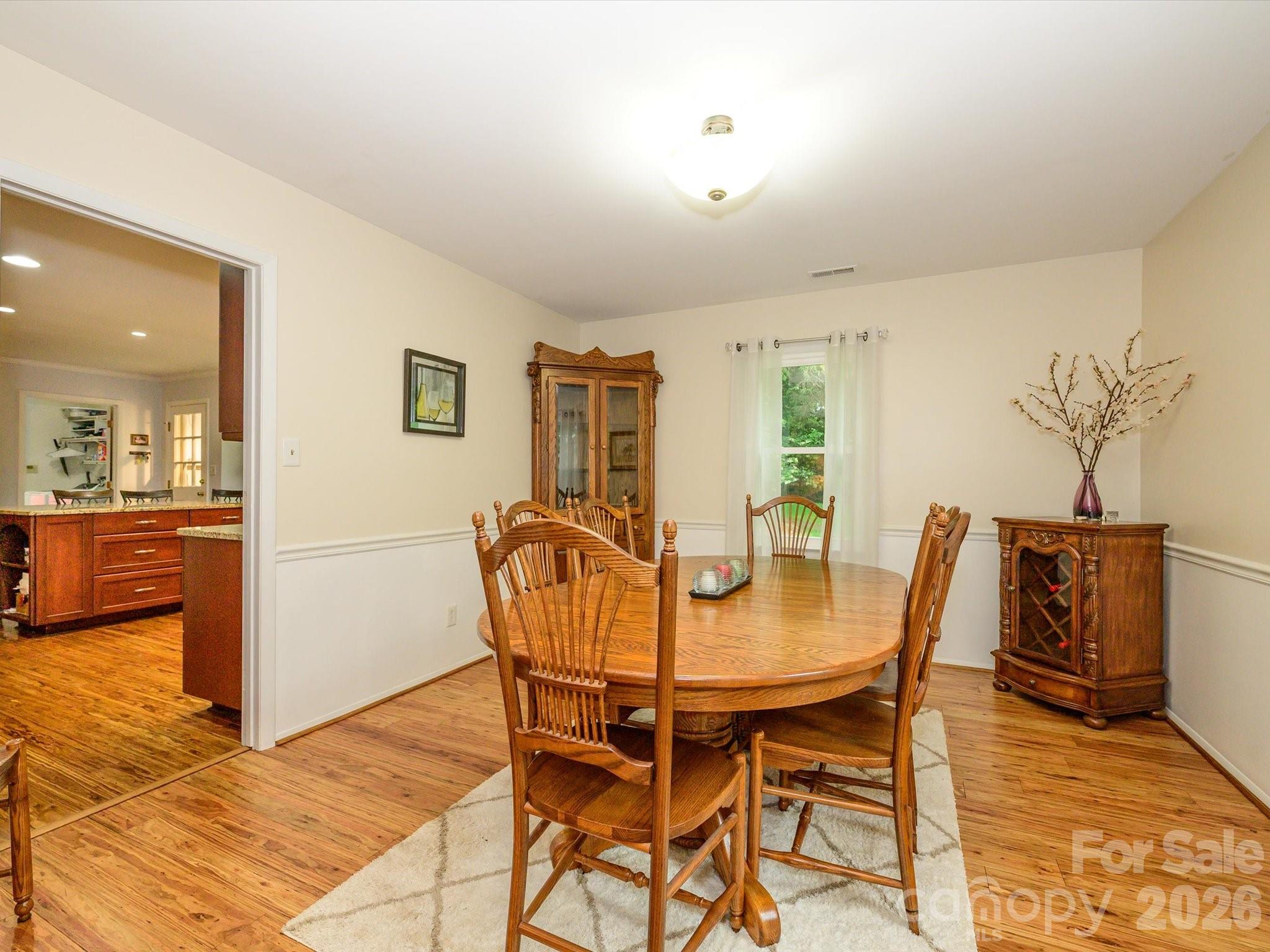 9607 Riddick Place Matthews, NC 28105 - Photo 11 of 39 a view of a dining room with furniture and wooden floor