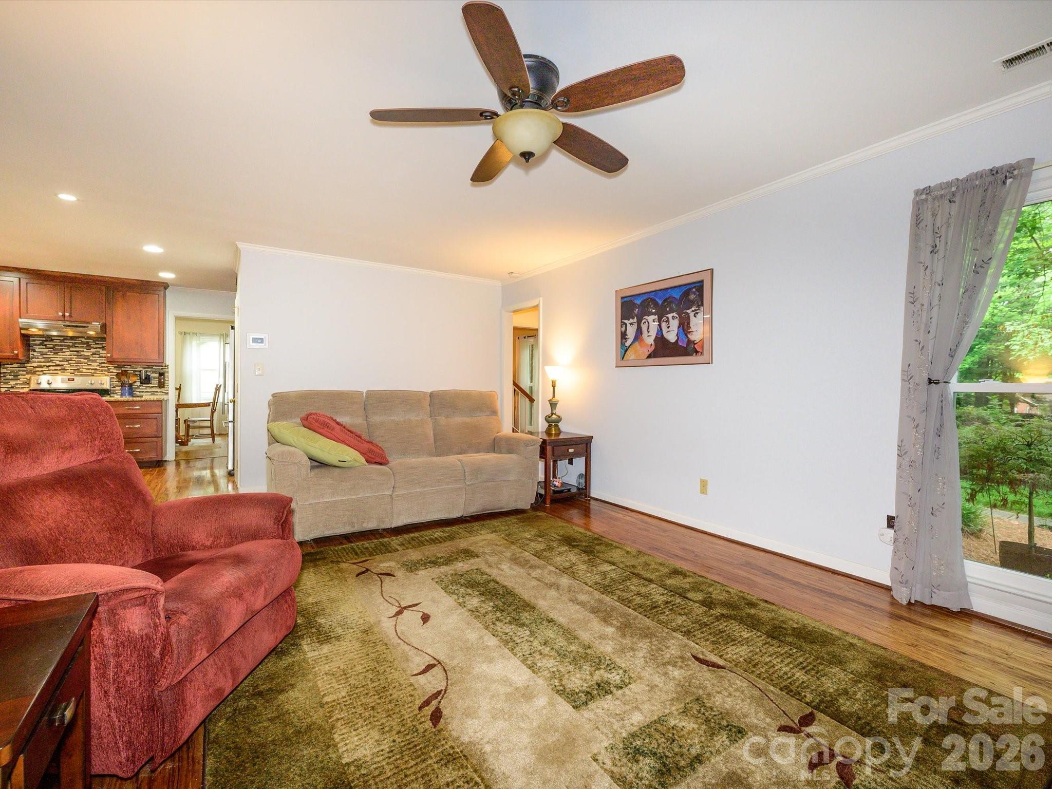 9607 Riddick Place Matthews, NC 28105 - Photo 17 of 39 a living room with furniture and a large window with garden view