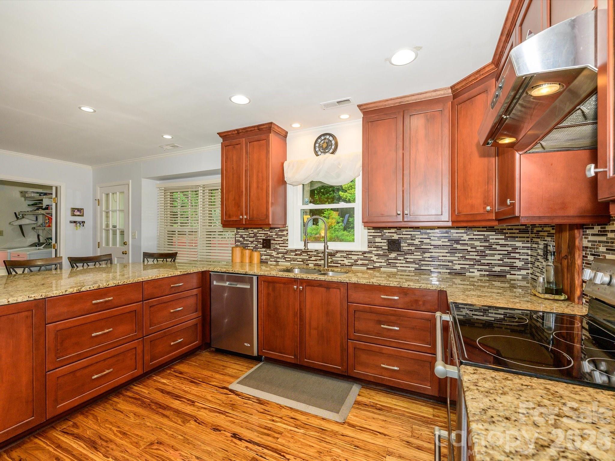 9607 Riddick Place Matthews, NC 28105 - Photo 20 of 39 a kitchen with stainless steel appliances granite countertop a sink and cabinets
