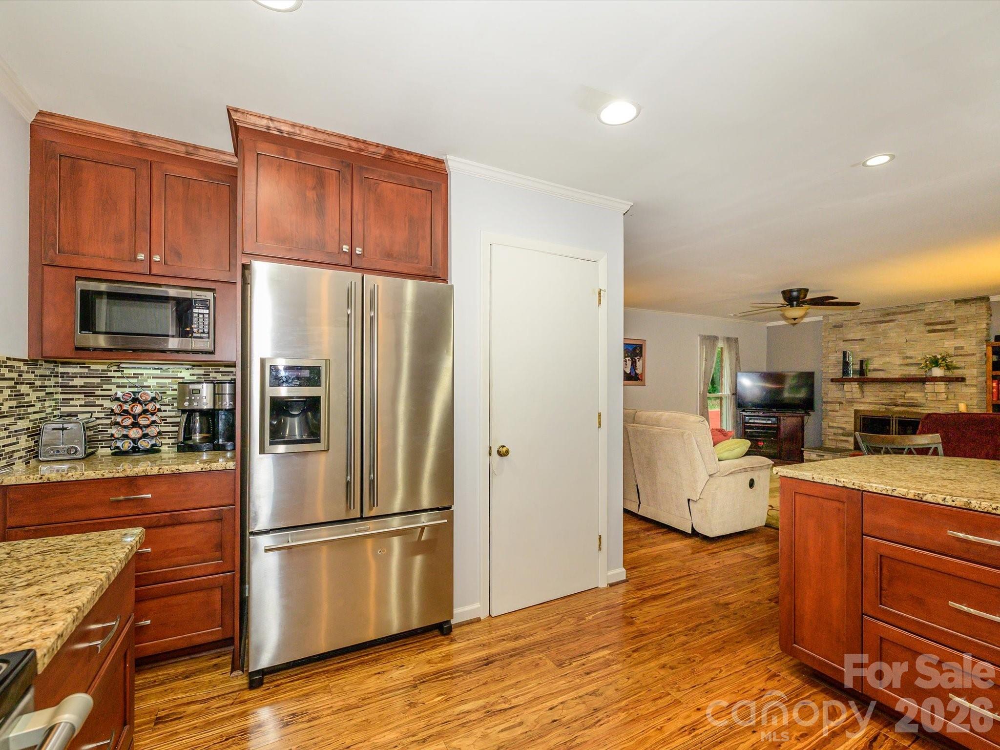 9607 Riddick Place Matthews, NC 28105 - Photo 21 of 39 a kitchen with stainless steel appliances a refrigerator and wooden cabinets