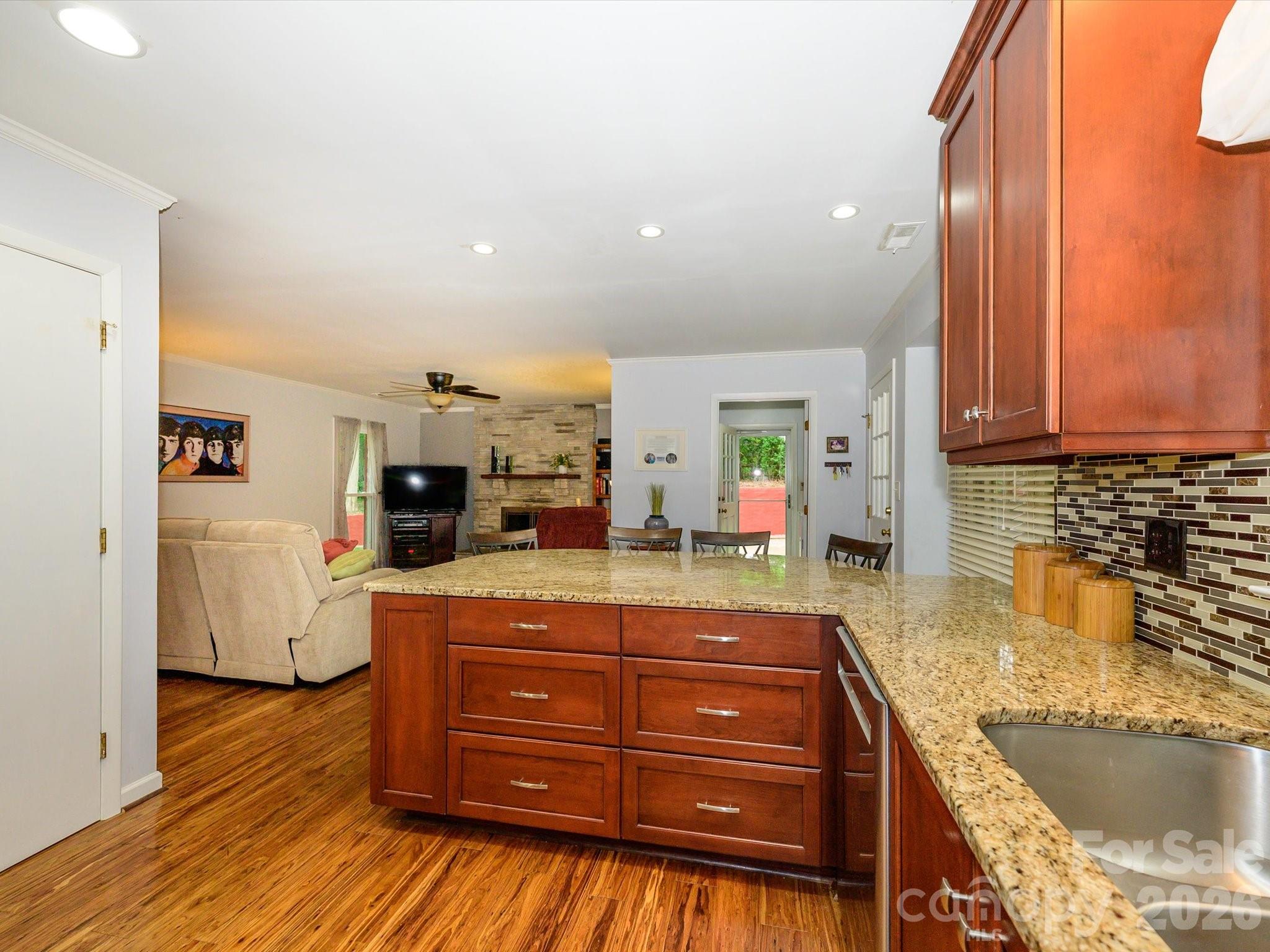 9607 Riddick Place Matthews, NC 28105 - Photo 22 of 39 a kitchen with a sink and wooden floor