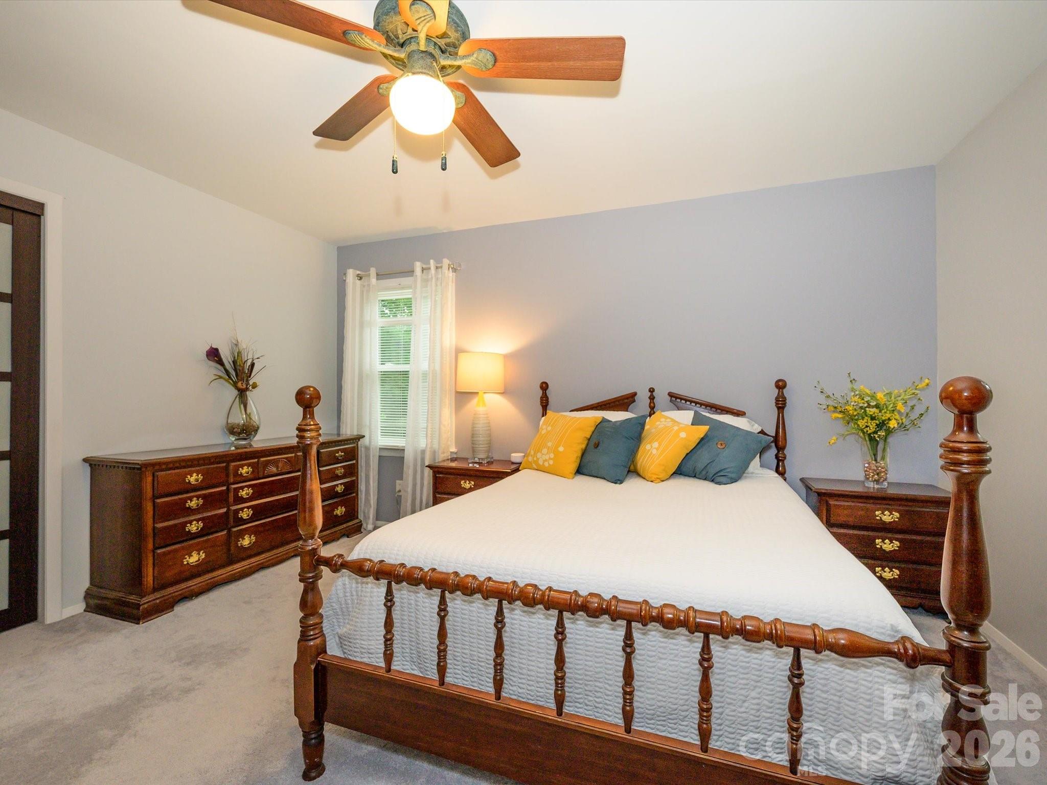 9607 Riddick Place Matthews, NC 28105 - Photo 24 of 39 a bedroom with a bed and a chandelier