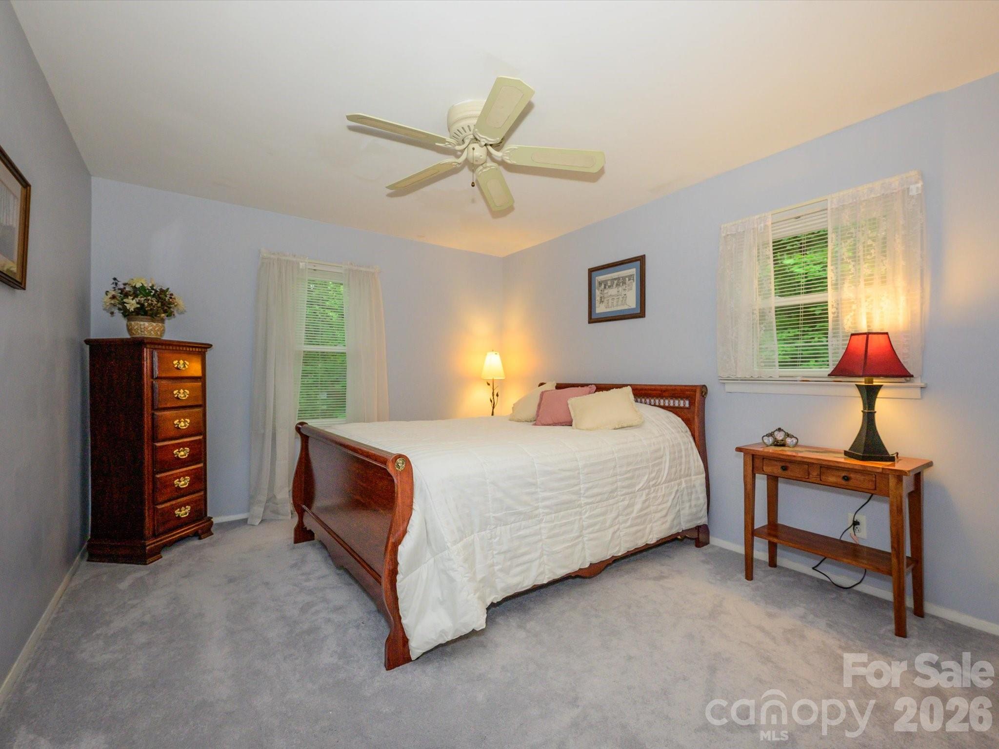 9607 Riddick Place Matthews, NC 28105 - Photo 29 of 39 a bedroom with a bed and a chandelier
