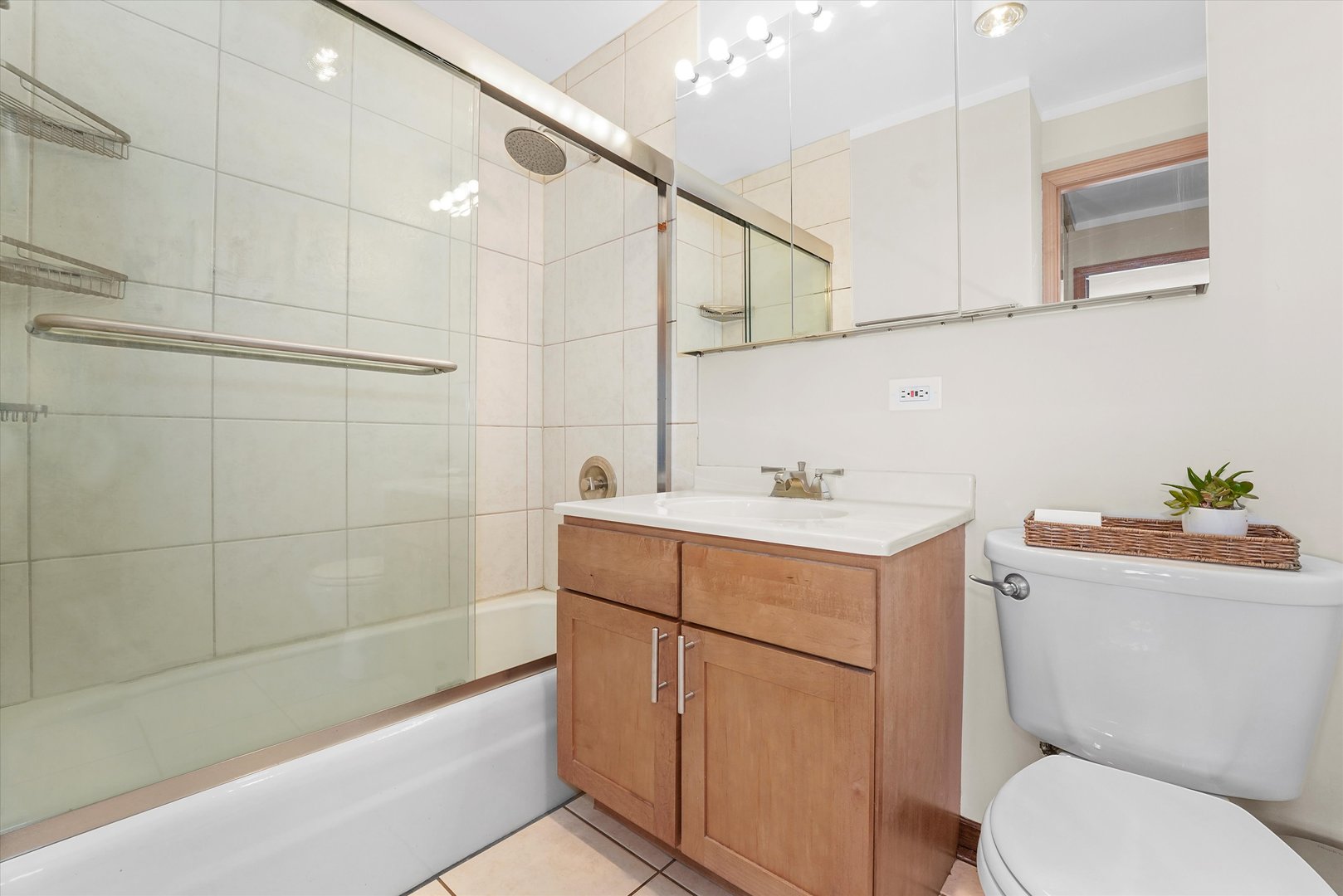 655 West Irving Park Road, Unit 3916 Chicago, IL 60613 - Photo 12 of 17 a bathroom with a sink mirror vanity and toilet