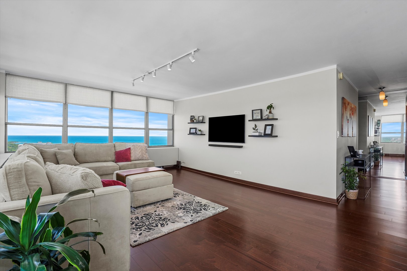 655 West Irving Park Road, Unit 3916 Chicago, IL 60613 - Photo 3 of 17 a living room with furniture and a flat screen tv