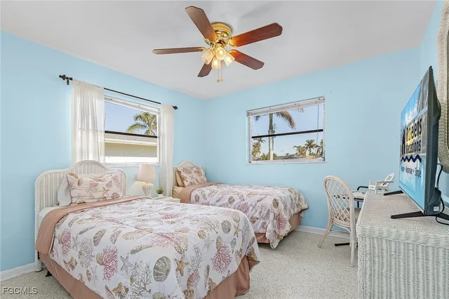 a bedroom with two beds and a window