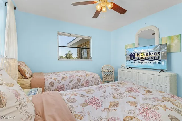 a bedroom with two beds and a dresser