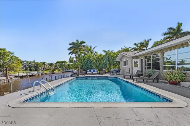 a swimming pool with outdoor seating and yard