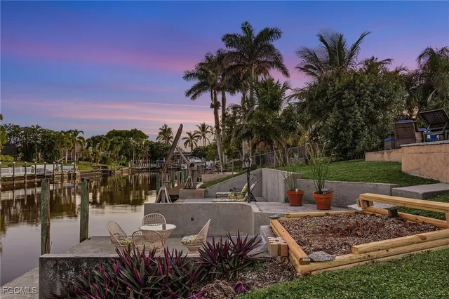 a view of a swimming pool with a patio and a garden