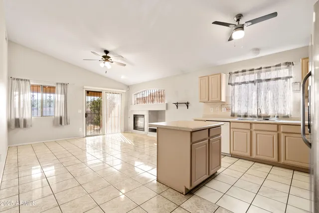 a kitchen with granite countertop white cabinets and white stainless steel appliances