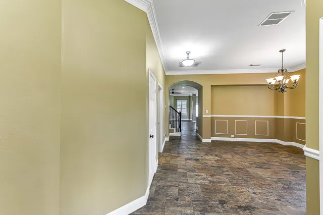 a view of a hallway with wooden shelves