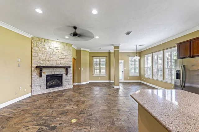 a view of an empty room with a fireplace and a window