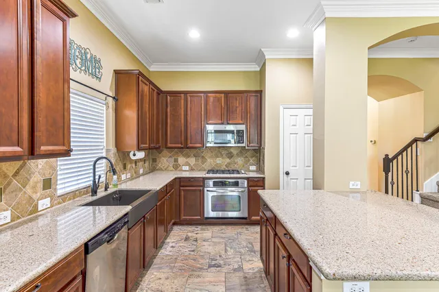 a kitchen with stainless steel appliances granite countertop a sink and stove