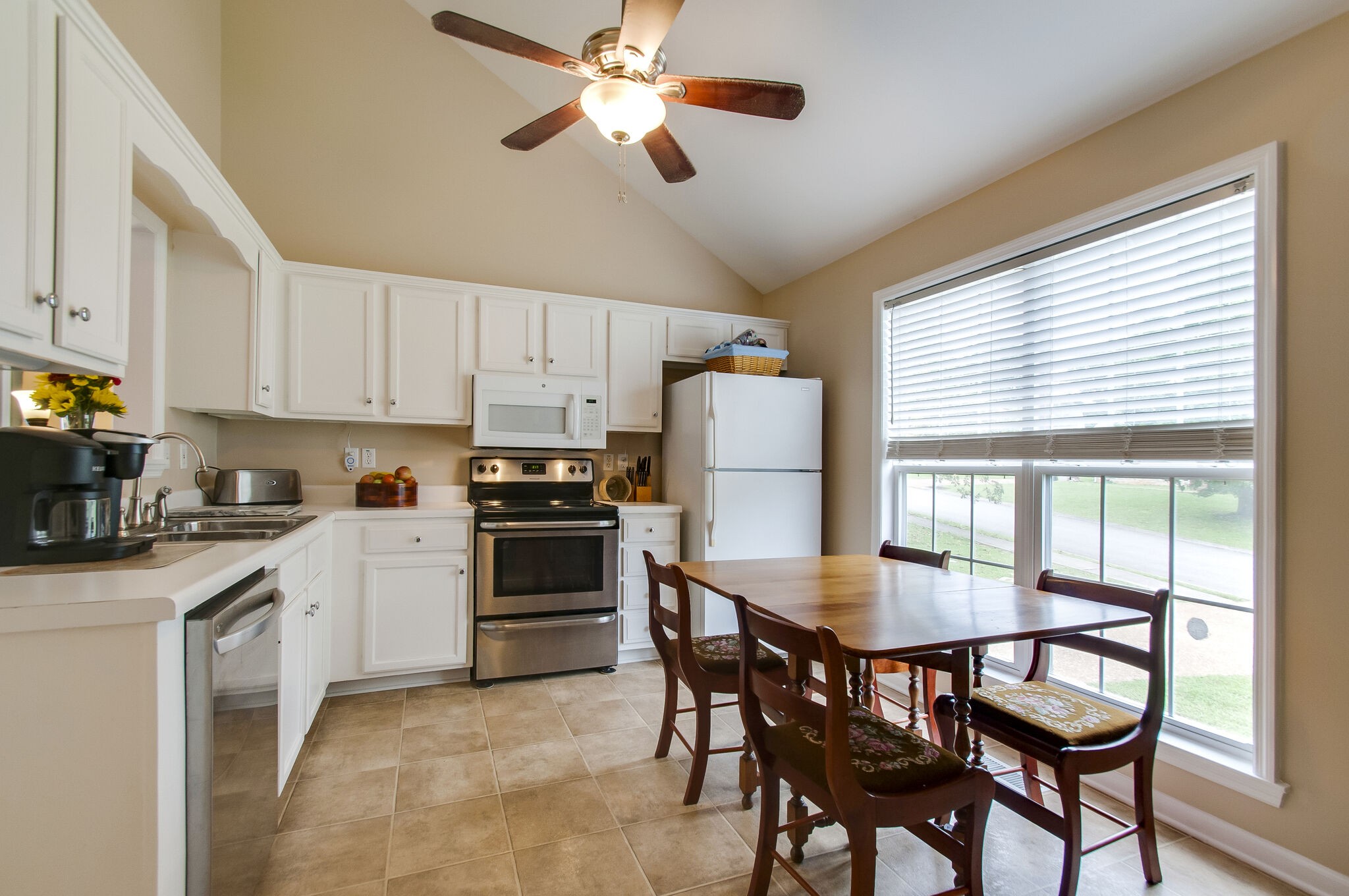 7487 Christopher Street Fairview, TN 37062 - Photo 13 of 27 a kitchen with a dining table chairs and refrigerator