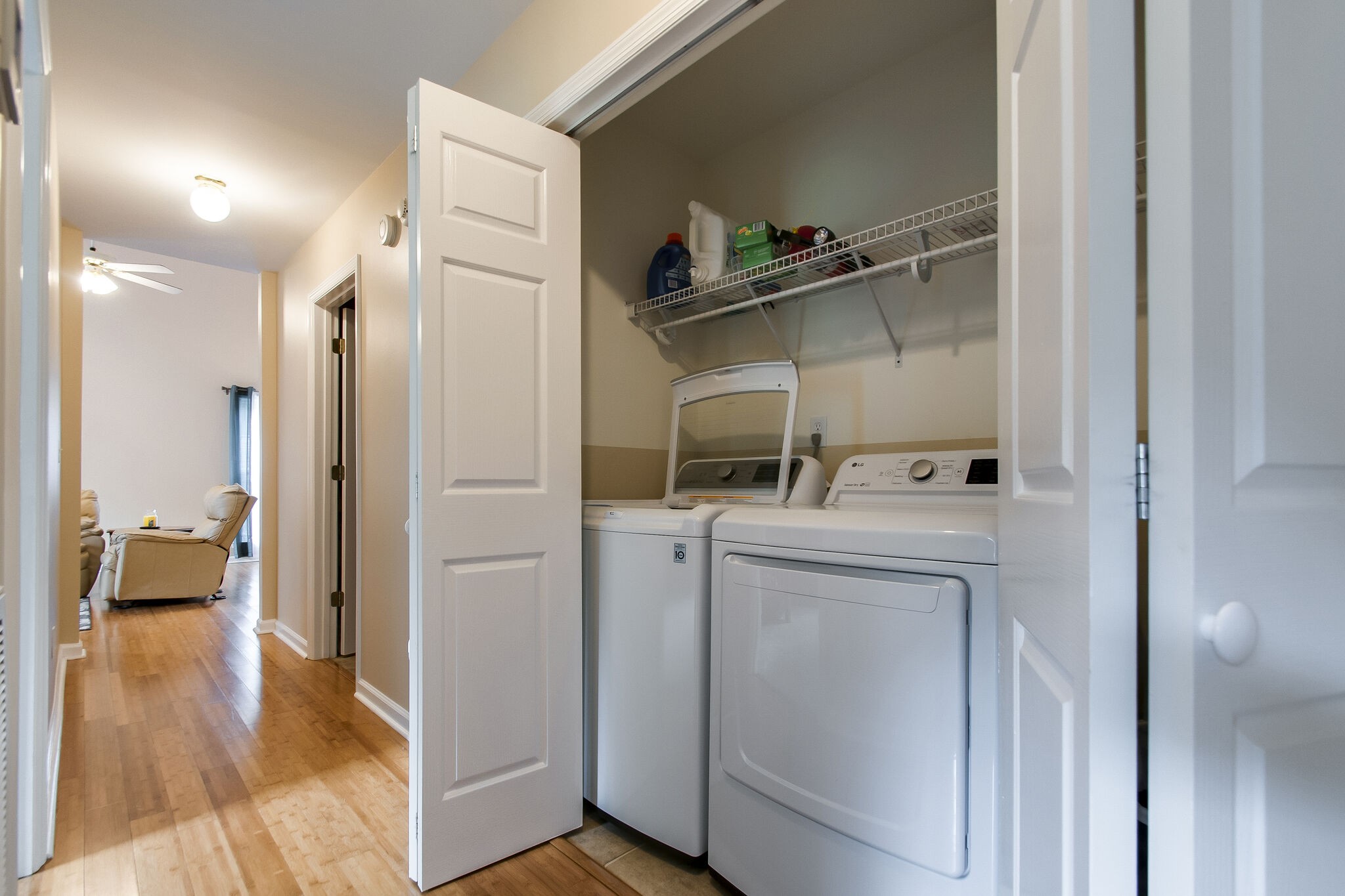 7487 Christopher Street Fairview, TN 37062 - Photo 20 of 27 a kitchen with white cabinets and wooden floor