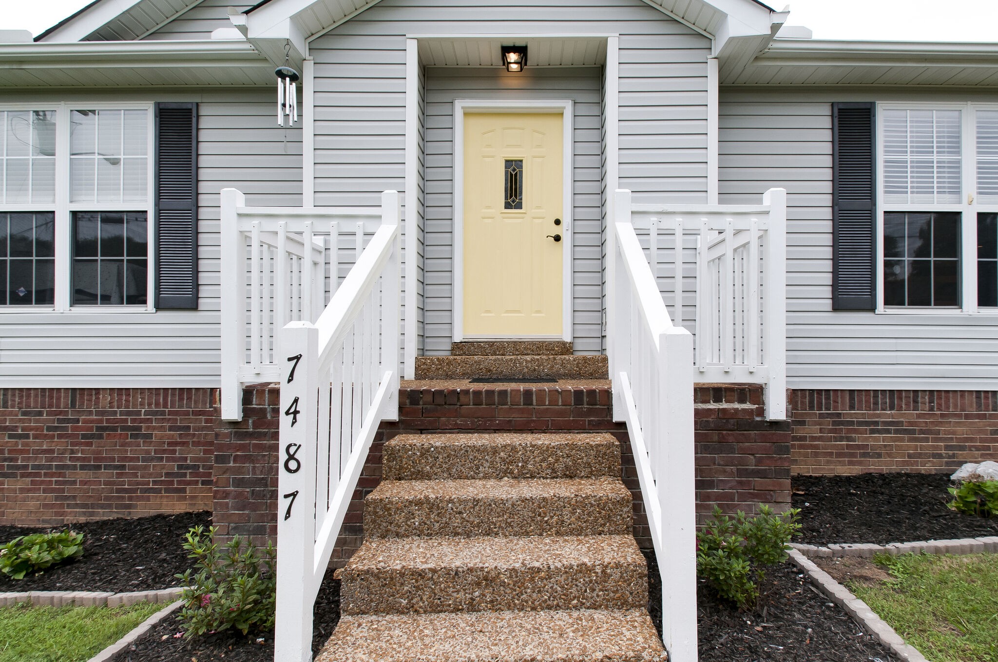 7487 Christopher Street Fairview, TN 37062 - Photo 4 of 27 a view of a brick house with many windows