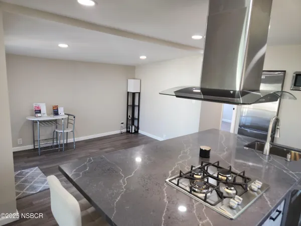a living room with furniture and a gym equipment