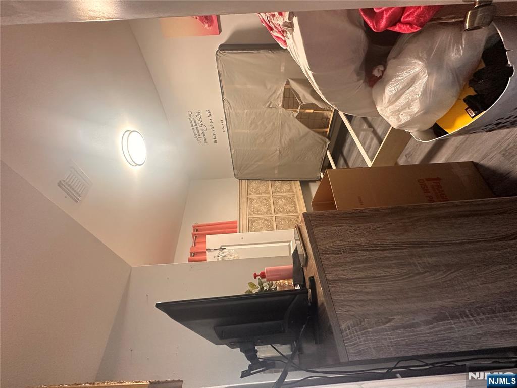 154 Butler Street Paterson, NJ 07524 - Photo 15 of 26 a living room with furniture and a flat screen tv