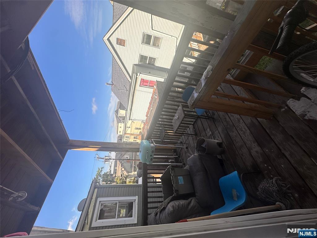 154 Butler Street Paterson, NJ 07524 - Photo 19 of 26 a view of a chairs and table in the balcony