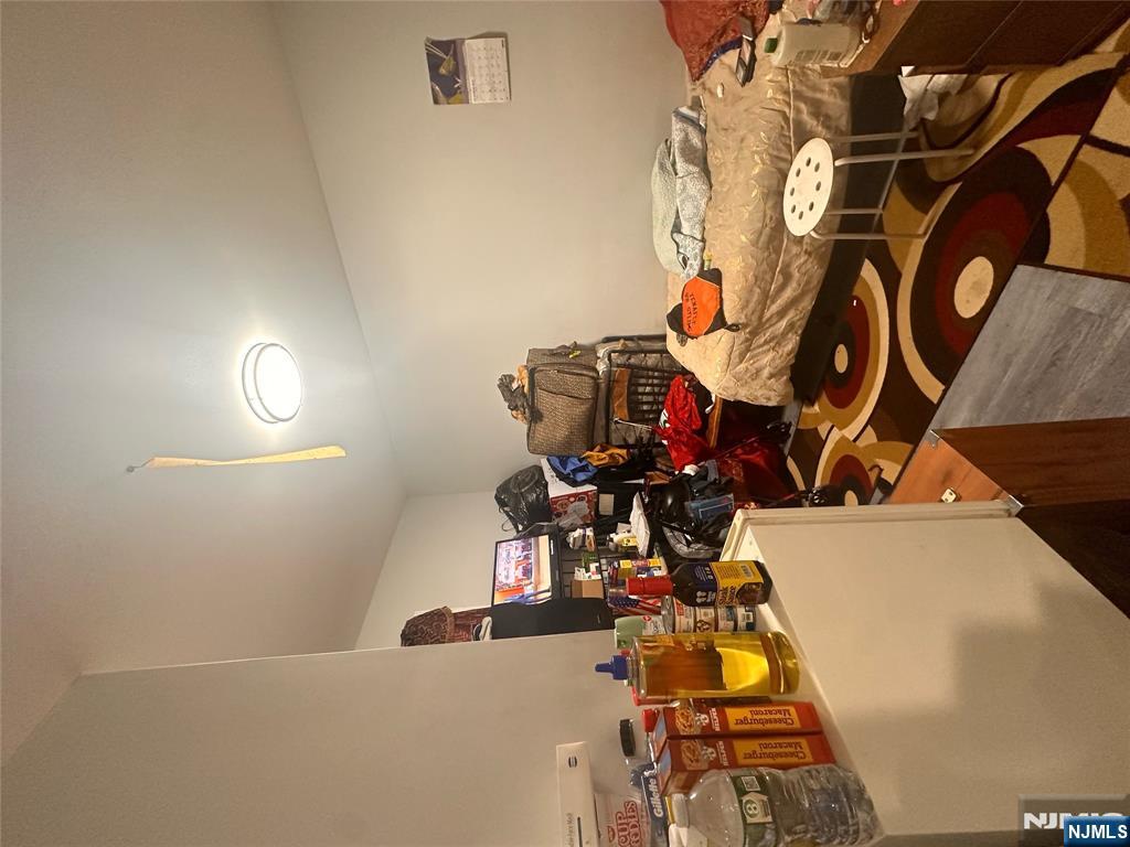 154 Butler Street Paterson, NJ 07524 - Photo 25 of 26 a bedroom with furniture and a wooden floor