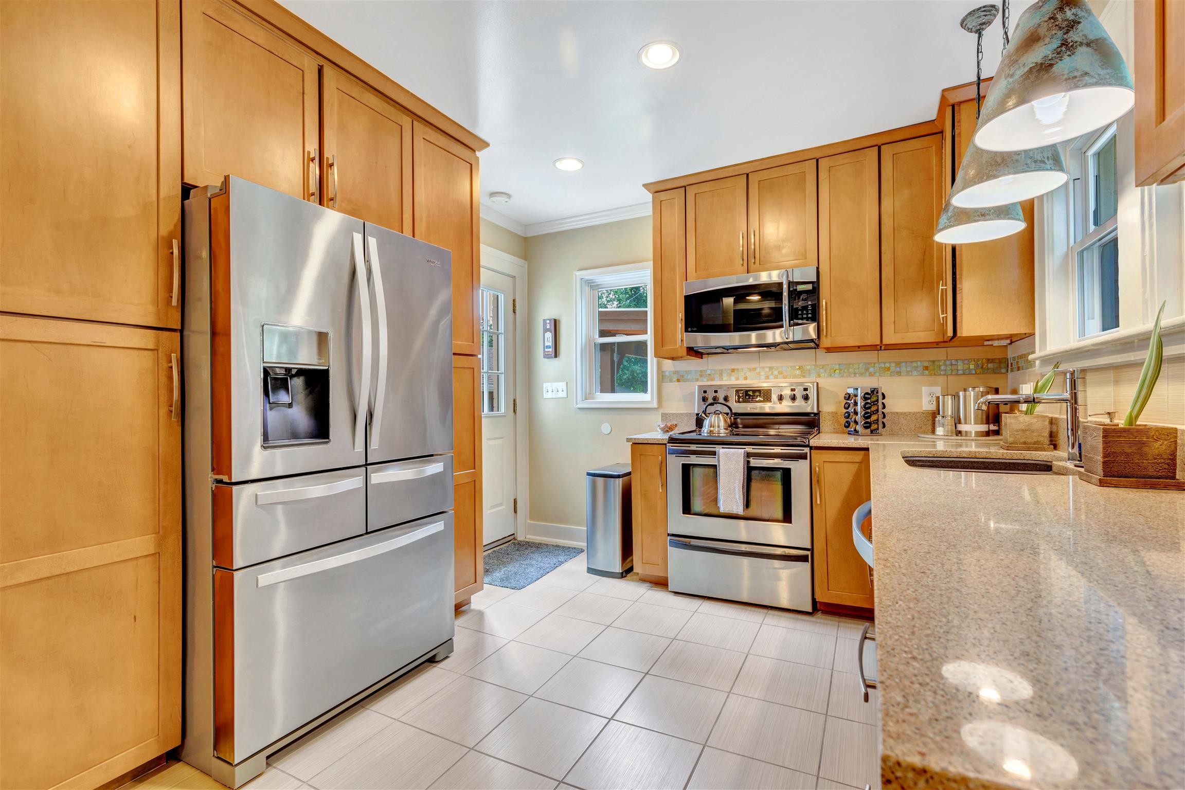 255 Cherokee Road Nashville, TN 37205 - Photo 11 of 30 a kitchen with stainless steel appliances granite countertop a refrigerator a stove and a sink with wooden floor